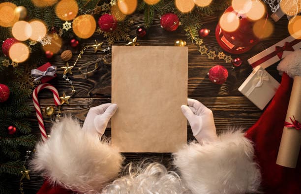 Christmas Experience Close up of Santa Claus hands holding letter