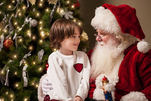 Christmas Experience Santa and the young boy by the Christmas tree